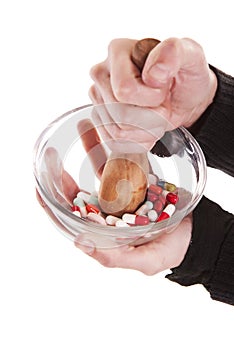 Person crushing pills in bowl