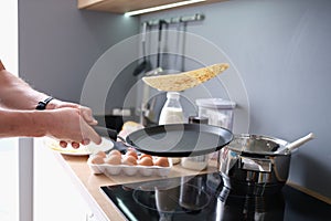 Person deftly flips the pancakes in pan