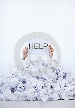 Person, desk and hands with pile of paperwork, sign and help with burnout, stress and administration. Debt, bills and