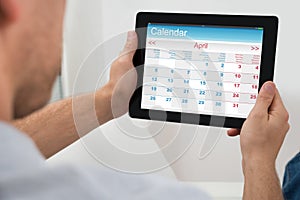 Person With Digital Tablet Showing Calendar