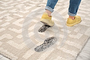 Person in dirty shoes leaving muddy footprints