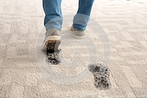 Person in dirty shoes leaving muddy footprints