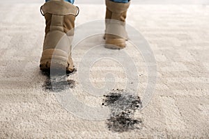 Person in dirty shoes leaving muddy footprints