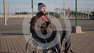 person with disease and immobility of lower body is resting on street