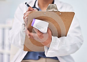 Person, doctor and writing on clipboard for prescription, diagnosis or results with thermometer at hospital. Closeup of