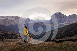 Person with a dog in the mountains. travel, hiking with a pet. Nova Scotia retriever with a girl.