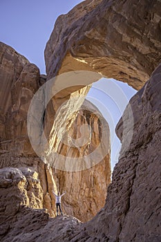 Person at Double Arch in Arches National Park