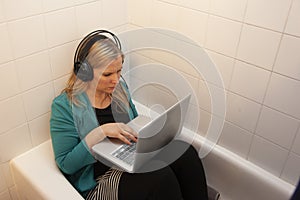 Person dressed for work in the tub