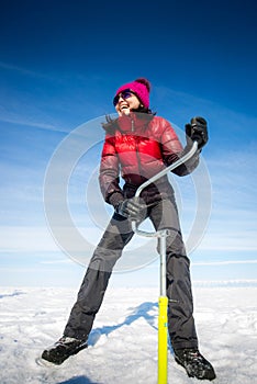 Person drilling ice in the winter
