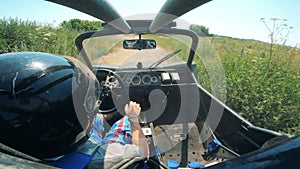 A person is driving a racing car across the terrain