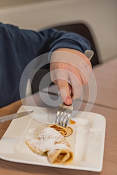 Person eating pancakes - dessert