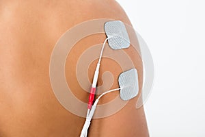 Person with electrodes on shoulder