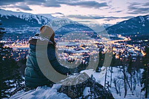 person enjoying a scenic view of a snow-covered lake from a mountaintop