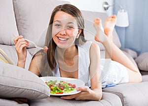 Person is enjoying tasty green salad