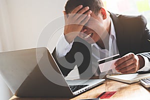 Person exhausted with bankruptcy problem. shocked man carrying bills and credit card on his hands worry about bank notification