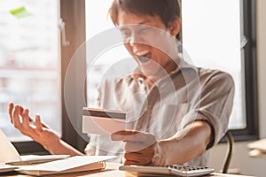 Person exhausted with bankruptcy problem. shocked man carrying bills and credit card on his hands worry about bank notification