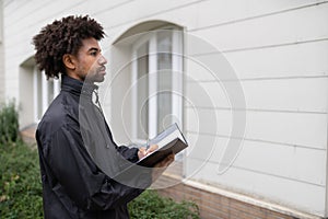 Person Filling Document In Front Of House