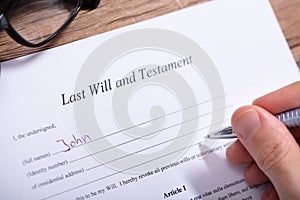 Person Filling Last Will And Testament Form