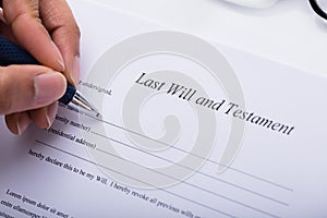 Person Filling Last Will And Testament Form