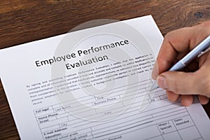 Person Filling A Performance Evaluation Form photo