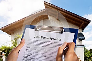 Person Filling Real Estate Appraisal Form photo