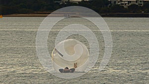 Person Floating on the Ocean in a Zorb Ball.