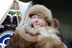 Person in fur hat and cape