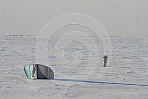 Person getting ready to kite skiing under grey overcast skies near Cambridge Bay photo