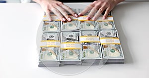 Person gives stacks of one million US dollars in one hundred dollar bills