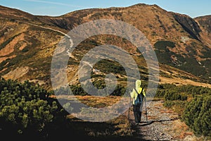 person going along winding road to the top of mountain