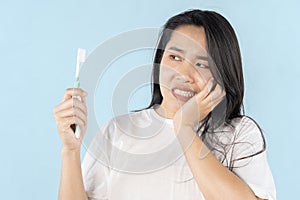 A person grimacing in pain as they brush their teeth. Close-up of a person\'s mouth with a toothbrush