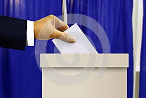 Person hand casting a vote