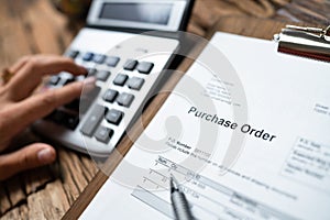 Person Hand Filling A Purchase Order Form photo