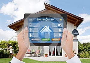 Person Hand Holding Digital Tablet With Home Control System