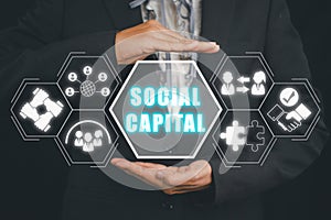 Person hand holding social capital icon on virtual screen