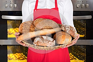 Person Hand Holding Plate Full Of Breads And Buns
