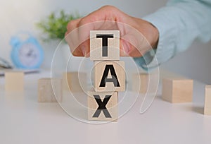 Person Hand Holding The Word Tax, Business Concept