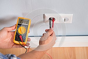 Person hand metering socket voltage photo