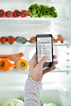 Person Hand With Mobile Phone Showing Shopping List