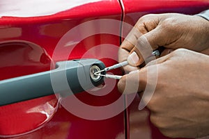 Person Hand Opening Car Door With Lockpicker