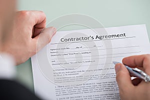 Person Hand Over Contractor`s Agreement Form