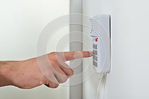 Person Hand Pressing Button On Security System