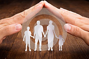Person Hand Protecting Family Papercut