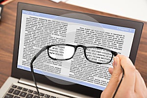 Person hand with spectacles and laptop