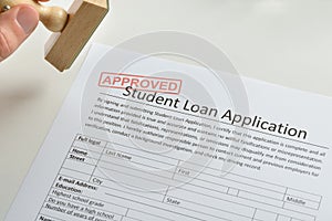 Person Hand With Stamp And Approved Loan Application