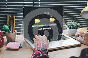 Person hand using laptop computer waiting for transfer file process with loading bar icon on virtual screen