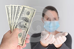 Person handing out money to unemployed woman