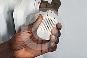 Person Hands Adjusting Thermostat Radiator