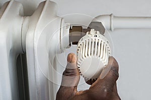 Person Hands Adjusting Thermostat Radiator