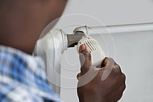 Person Hands Adjusting Thermostat Radiator